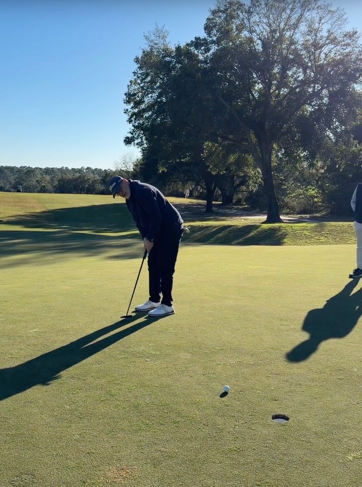 Golfer lining up a putt on the green